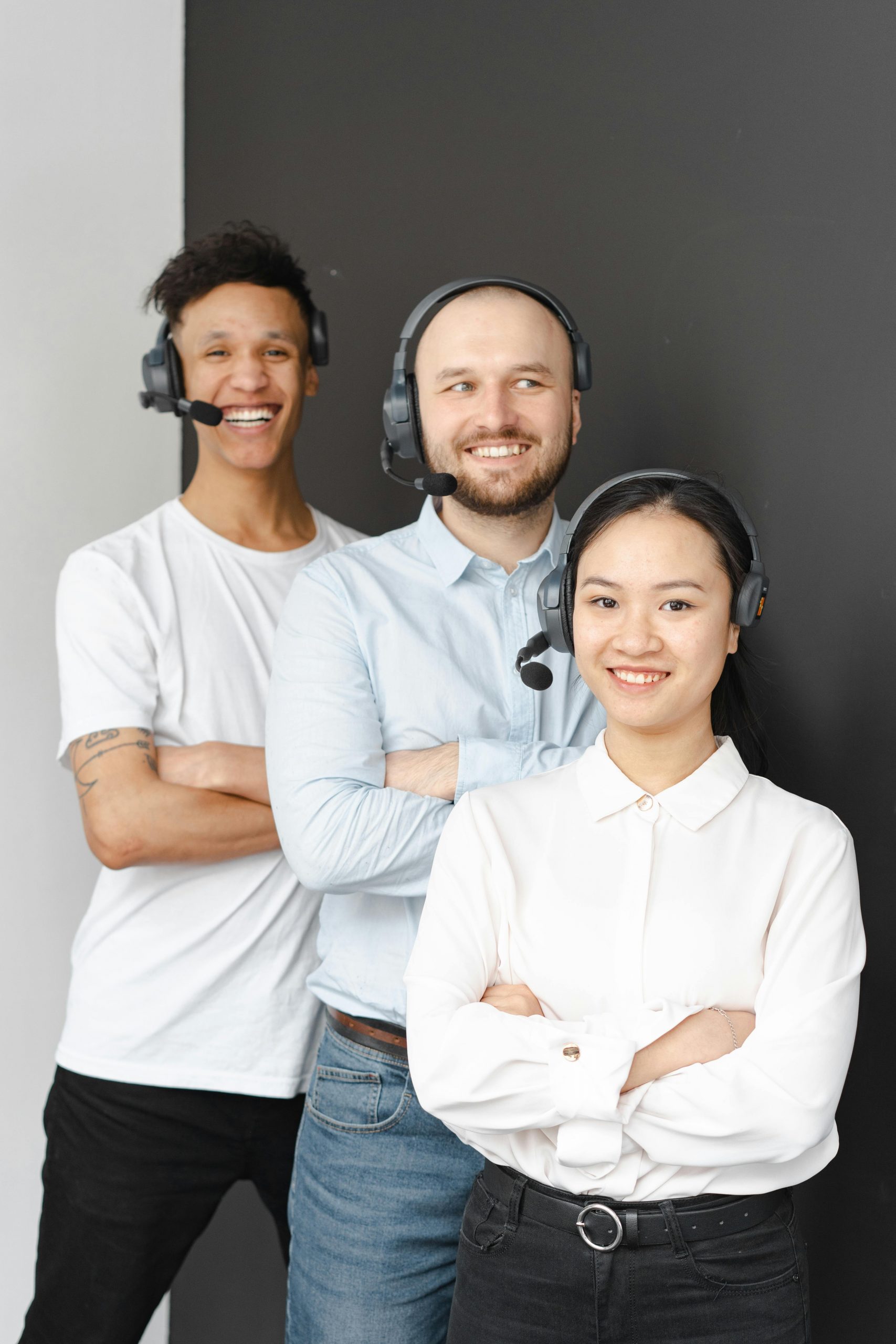 Smiling customer service team showcasing diversity and teamwork with headsets.